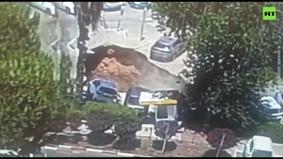 Moment GIANT sinkhole swallows cars in Jerusalem hospital parking lot